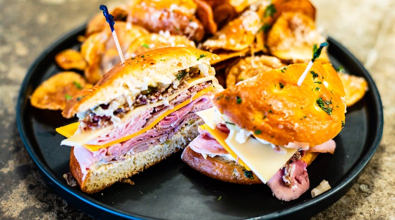 The Butcher the Baker’s muffuletta, served here with truffle-parmesan chips, is essentially a charcuterie board piled onto a sandwich.