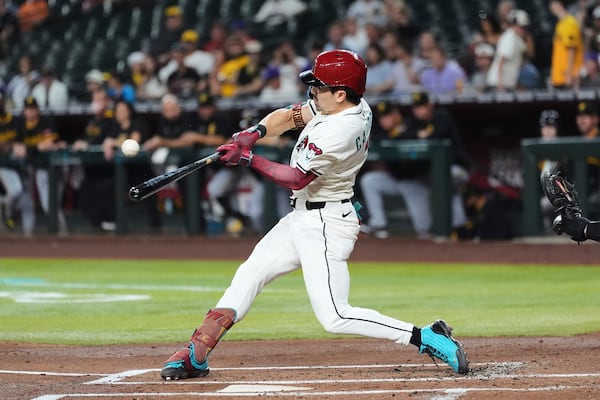 Arizona Diamondbacks' Corbin Carroll connects for a home run against the Pittsburgh Pirates during the first inning of a baseball game Tuesday, May 27, 2025, in Phoenix. (AP Photo/Ross D. Franklin)