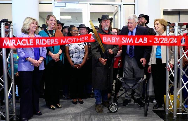 Scott Ressmeyer, co-owner of Country’s Barbecue and founder of the Miracle Ride, center, cuts the ribbon during a celebration of the new mother-baby simulation lab at Columbus State University’s School of Nursing. (Photo Courtesy of Mike Haskey)