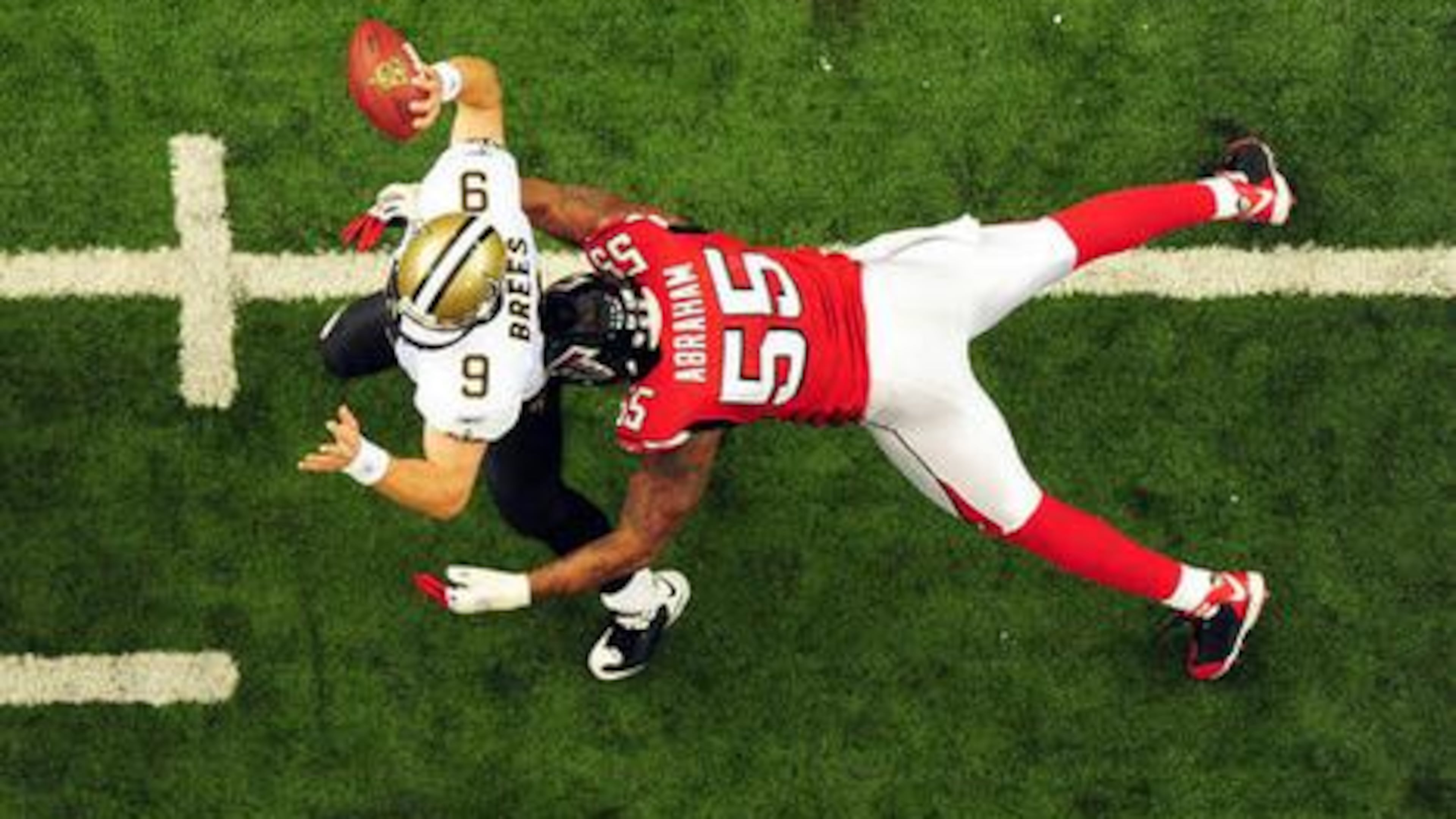 Former Falcons defensive end John Abraham (right) has been nominated for the Pro Football Hall of Fame Class of 2026. So has former New Orleans Saints quarterback Drew Brees. (AJC File)