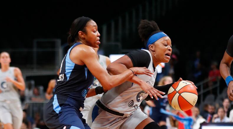 Minnesota Lynx guard Odyssey Sims (right) drives against Atlanta Dream guard Renee Montgomery. (AP Photo/John Bazemore)