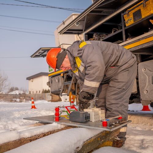 Electricians carry out emergency repairs on a power pole after a transformer burned out due to a voltage surge caused by regular Russian air attacks on the country's energy infrastructure in Kyiv region, Ukraine, Wednesday, Jan. 14, 2026. (AP Photo/Dan Bashakov)