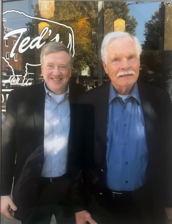 Jack Womack, who worked at CNN for nearly 40 years from the Ted Turner days through Warner Bros. Discovery, stands with Turner in 2021 outside Ted's Montana Grill. (Courtesy of Jack Womack)