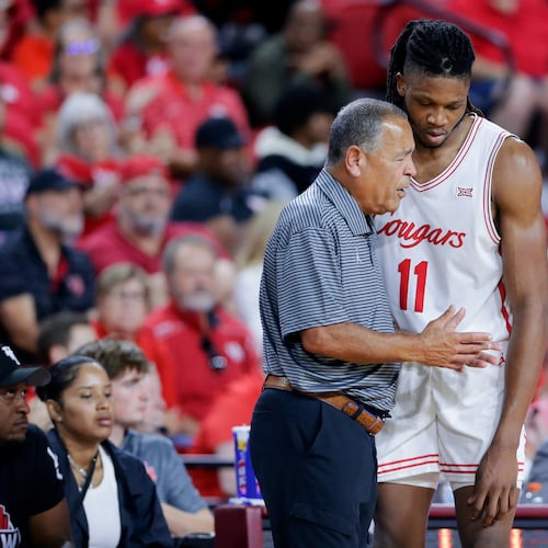 Houston head coach Kelvin Sampson, left, talks with forward Joseph Tugler (11) at the bench during the second half of an NCAA college basketball exhibition game against Mississippi State, Sunday, Oct. 26, 2025, in Rosenberg, Texas. (AP Photo/Michael Wyke)