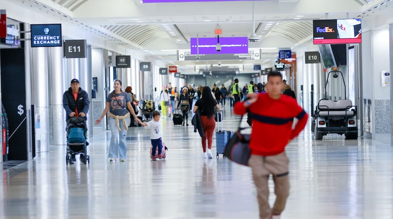 Travelers walk through Concourse E inside the Hartsfield-Jackson Atlanta International Airport. Three new gates have been built off the end of the concourse. (Miguel Martinez/AJC 2023)
