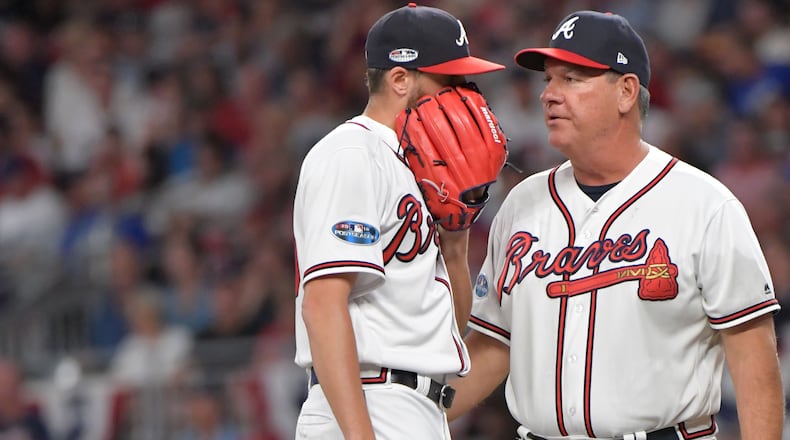 Atlanta Braves pitching coach Chuck Hernandez talks with relief pitcher Kevin Gausman after giving up a two-run single in the third inning against the Los Angeles Dodgers during Game 3 of a National League Division Series game Friday, Oct. 7, 2018, in Atlanta.