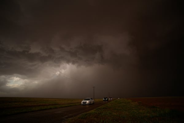 Cars dive away from a storm during a Project ICECHIP operation Thursday, June 5, 2025, in Morton, Texas. (AP Photo/Carolyn Kaster)