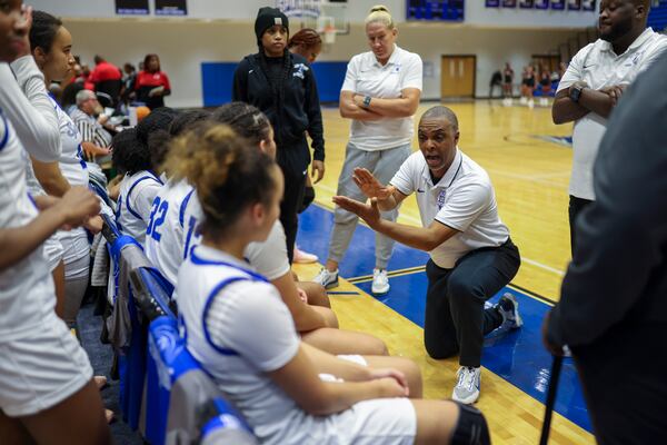 Campbell girls basketball coach Randy McClure (right center) talks with players during a timeout against Osborne on Tuesday, Jan. 13, 2026, in Smyrna. McClure had coached the team for 40 seasons before he was let go in March, a decision that was ultimately reversed. (Jason Getz/AJC)
