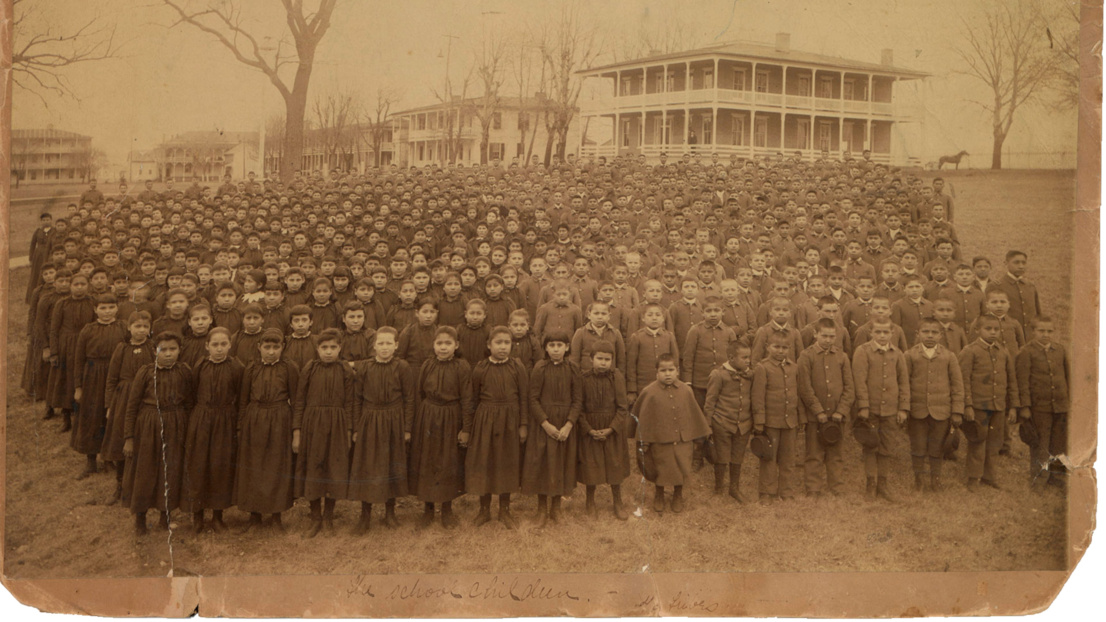 This photo provided by the Carlisle Indian School Digital Resource Center shows the 1892 student body of the Carlisle Indian Industrial School assembled on the school grounds in Carlisle, Pa. (John N. Choate via AP)