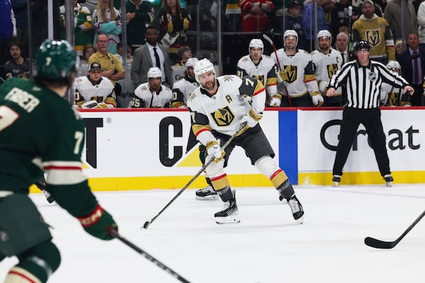 Vegas Golden Knights defenseman Ben Hutton (17) handles the puck against the Minnesota Wild during overtime in Game 4 of an NHL hockey Stanley Cup first-round playoff series, Saturday, April 26, 2025, in St. Paul, Minn. (AP Photo/Stacy Bengs)
