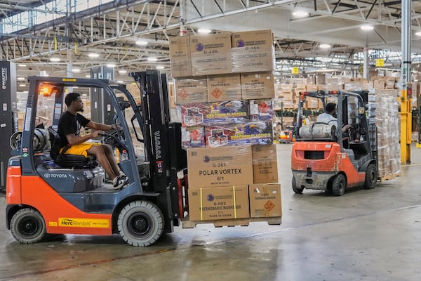 A worker uses a forklift to move fireworks in preparation for shipping, at the Phantom Fireworks warehouse in Warren, Ohio Wednesday, June 25, 2025. (AP Photo/Sue Ogrocki)