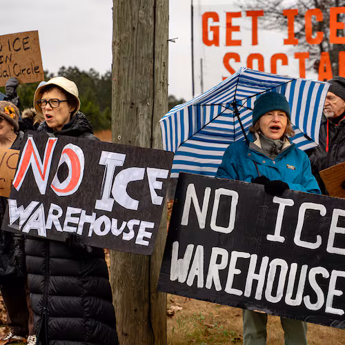 Protesters gather on Social Circle Parkway in the city of Social Circle to voice opposition to the Department of Homeland Security buying and converting a warehouse into an immigrant detention facility on Wednesday, Jan 14, 2026. The city filed a federal lawsuit Wednesday to block the Trump administration from doing so. (Ben Hendren/AJC)