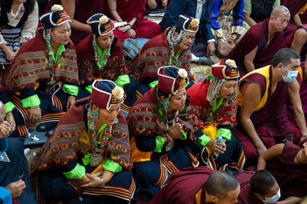 Devotees watch Tibetan spiritual leader the Dalai Lama on a television screen at an event during which Tibetan exiles prayed for the Tibetan leader's longevity, a day before his 90th birthday, in Dharamshala, India, Saturday, July 5, 2025.(AP Photo/Ashwini Bhatia)