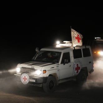 Red Cross vehicles carrying the bodies of three people believed to be deceased hostages handed over by Hamas make their way toward the border crossing with Israel, to be transferred to Israeli authorities, in Deir al-Balah, central Gaza Strip, Sunday, Nov. 2, 2025. (AP Photo/Jehad Alshrafi)