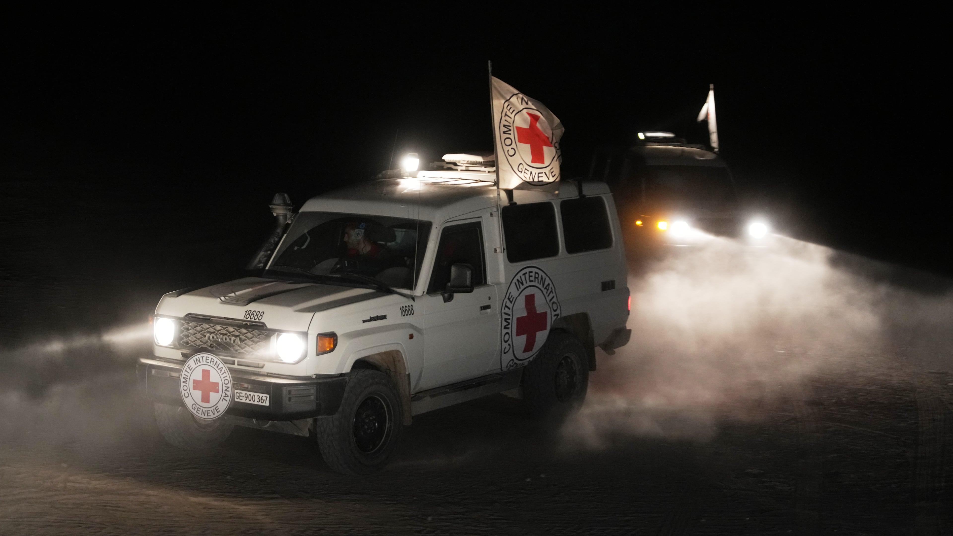 Red Cross vehicles carrying the bodies of three people believed to be deceased hostages handed over by Hamas make their way toward the border crossing with Israel, to be transferred to Israeli authorities, in Deir al-Balah, central Gaza Strip, Sunday, Nov. 2, 2025. (AP Photo/Jehad Alshrafi)