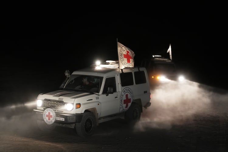 Red Cross vehicles carrying the bodies of three people believed to be deceased hostages handed over by Hamas make their way toward the border crossing with Israel, to be transferred to Israeli authorities, in Deir al-Balah, central Gaza Strip, Sunday, Nov. 2, 2025. (AP Photo/Jehad Alshrafi)