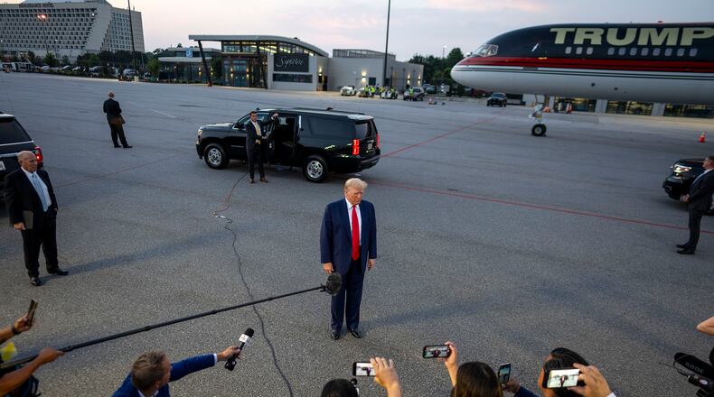 Donald Trump speaks to reporters at Hartsfield-Jackson International Airport after surrendering at the Fulton County jail in Atlanta on Thursday, Aug. 24, 2023. The former president’s campaign immediately began fund-raising off his booking photo and started selling merchandise featuring it.. (Doug Mills/The New York Times)
