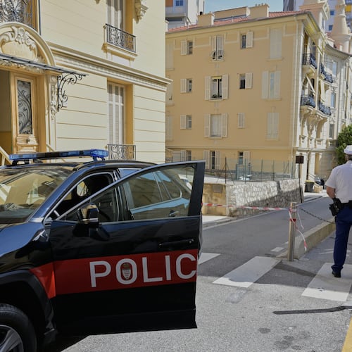 A police officer guards in a street in Monaco, Tuesday, June 30, 2026, a day after an explosive device seriously injured three people at a residential building in Monaco. (AP Photo/Philippe Magoni)