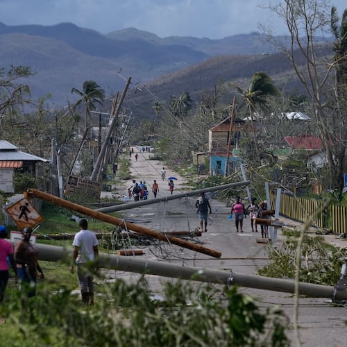 Residents walk through Lacovia Tombstone, Jamaica, in the aftermath of Hurricane Melissa, Wednesday, Oct. 29, 2025. (AP Photo/Matias Delacroix)