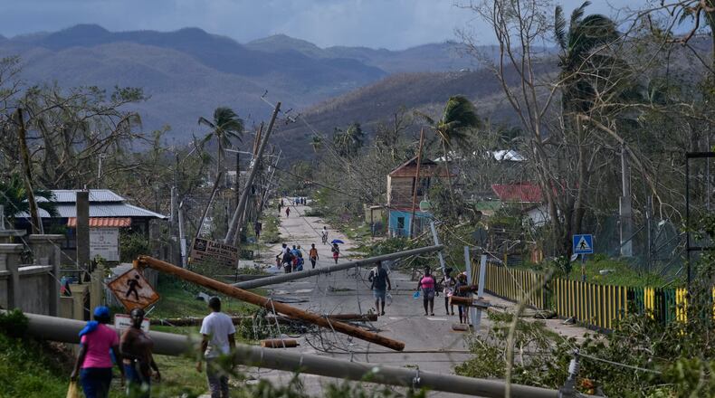 Residents walk through Lacovia Tombstone, Jamaica, in the aftermath of Hurricane Melissa, Wednesday, Oct. 29, 2025. (AP Photo/Matias Delacroix)