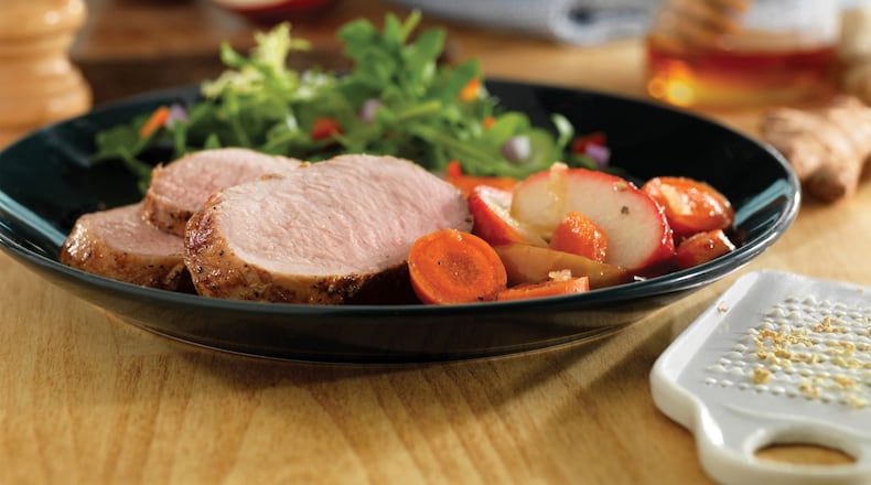 Sunday’s Honey-Ginger Pork Tenderloin With Carrots and Apples is served with oven-roasted potatoes. Credit: PorkBeInspired.com