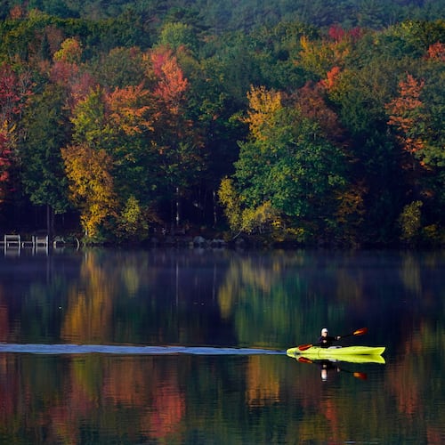 FILE - Virginia Davidson of Bridgton, Maine, paddles her kayak on Moose Pond, Oct. 13, 2021, in Bridgton, Maine. (AP Photo/Robert F. Bukaty)