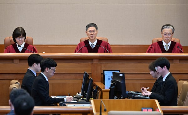Moon Hyung-bae, center, acting chief justice of South Korea's Constitutional Court, speaks during the final ruling of South Korean President Yoon Suk Yeol's impeachment at the Constitutional Court on Friday, April 4, 2025 in Seoul, South Korea. (Kim Min-Hee, Japan Pool/Kyodo News via AP)