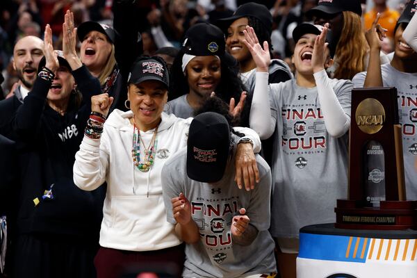 South Carolina head coach Dawn Staley, center left, celebrates with players after defeating Duke to advance to the Final Four in the Elite Eight of the NCAA college basketball tournament, Sunday, March 30, 2025, in Birmingham, Ala. (AP Photo/Butch Dill)