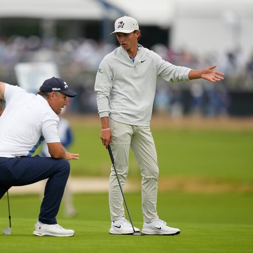 Miles Russell and Padraig Harrington, of Ireland, talk on the fourth hole during the first round of the U.S. Open golf tournament at Shinnecock Hills Golf Club in Southampton, N.Y., Thursday, June 18, 2026.(AP Photo/Seth Wenig)
