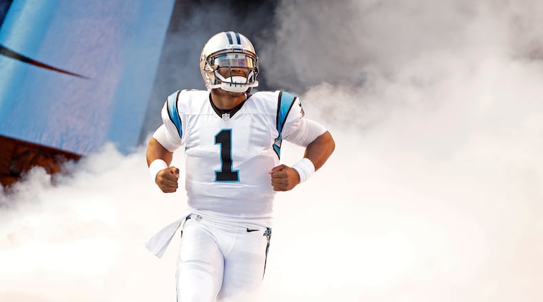 Cam Newton bursts onto the field for the Carolina Panthers' preseason game against the Miami Dolphins on Aug. 22 in Charlotte. The Panthers won 31-30. AP Photo/Bob Leverone