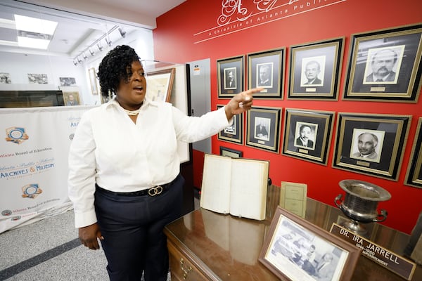 Atlanta Public Schools Superintendent Lisa Herring points to photographs of previous superintendents on display inside the APS Archive Museum at their downtown office as the APS commemorates its 150-year history. (Miguel Martinez / miguel.martinezjimenez@ajc.com)