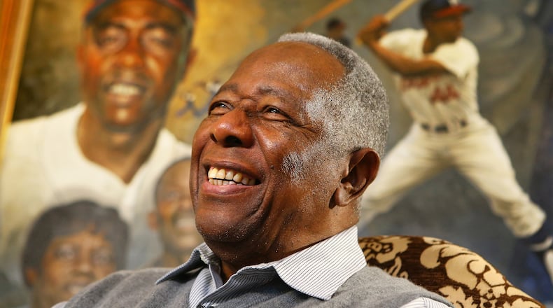 012214 ATLANTA:  Braves legend Hank Aaron breaks into a smile while reflecting on his life and career in the living room of his home on the eve of his 80th birthday, Tuesday, Jan. 21, 2014, in Atlanta. Made with a Canon EOS 1DX camera, 24-70 mm lens at 70mm, aperature f 4.5, shutter speed 1/125, and ISO speed rating 3200.    CURTIS COMPTON / CCOMPTON@AJC.COM