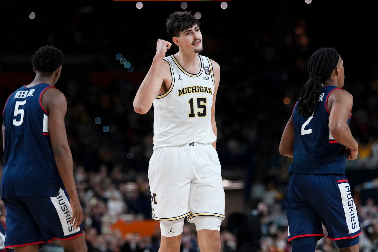 Michigan center Aday Mara — pictured in the national championship game against UConn in April — is 21 years old, 7-foot-3 and 260 pounds, and he has named Big 10 Defensive Player of the Year last season. (Abbie Parr/AP)