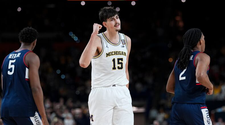 Michigan center Aday Mara — pictured in the national championship game against UConn in April — is 21 years old, 7-foot-3 and 260 pounds, and he has named Big 10 Defensive Player of the Year last season. (Abbie Parr/AP)