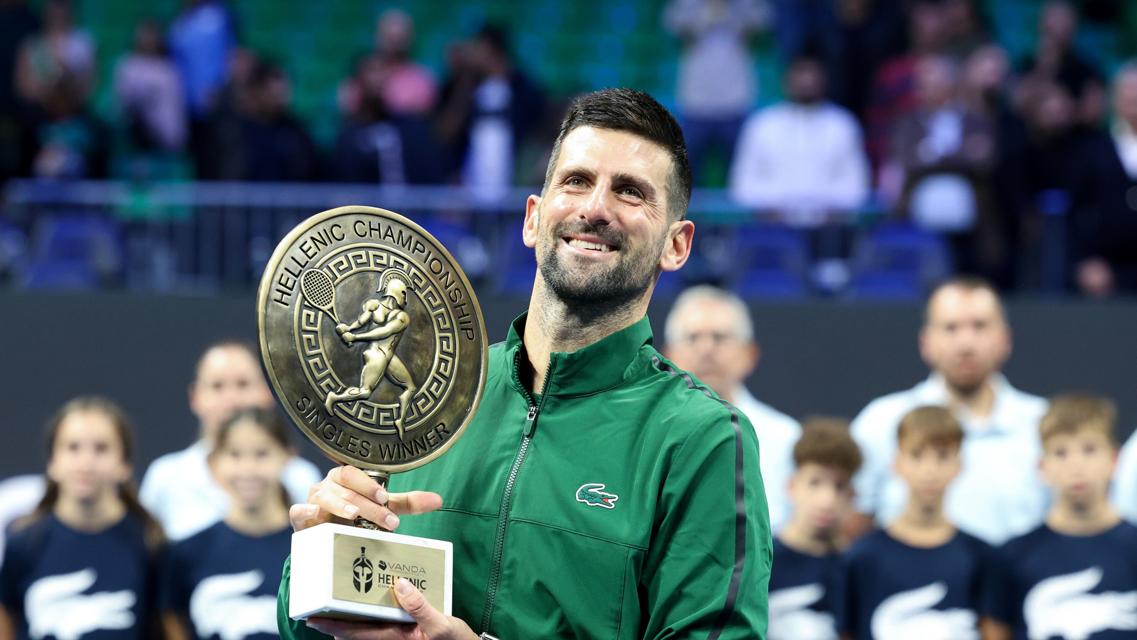 Novak Djokovic of Serbia raises the trophy of the ATP 250 tennis tournament after winning the final match against Lorenzo Musetti of Italy, in Athens, Greece, Saturday, Nov. 8, 2025. (AP Photo/Yorgos Karahalis)