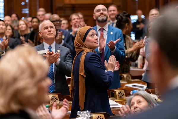 State Rep. Ruwa Romman (center), D-Duluth, claps before Gov. Brian Kemp's final State of the State speech earlier this year. (Arvin Temkar/AJC)