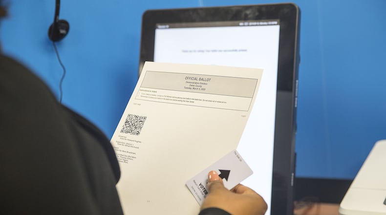 Breanna Thomas, election liaison for the Georgia Secretary of State, looks over her ballot after using the new Georgia voting machine during a demonstration at the James H. “Sloppy” Floyd building in Atlanta, Monday, September 16, 2019. Next to the touchscreen, an HP printer creates a paper ballot. The ballot includes a text listing of voters’ choices along with a bar code that can be read by an optical scanning machine. Voters can review their choices for accuracy and request a new ballot if needed. (Alyssa Pointer/alyssa.pointer@ajc.com)