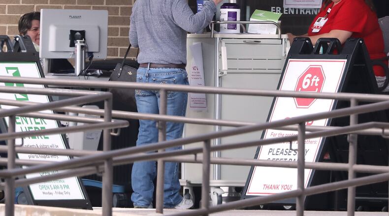 A woman arrives at a screening station for coronavirus in front of the emergency department entrance at Cartersville Medical Center before entering the hospital on Tuesday, March 17, 2020. Curtis Compton/ccompton@ajc.com