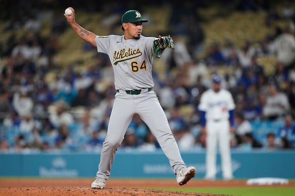 Athletics' Jhonny Pereda throws to a Los Angeles Dodgers batter during the eighth inning of a baseball game Thursday, May 15, 2025, in Los Angeles. (AP Photo/Mark J. Terrill)
