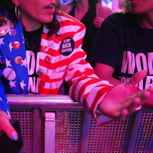 An attendee wears a pin reading "STOP DATA CENTERS" during a primary election night event for Abdul El-Sayed, a progressive candidate in the Democratic primary for U.S. Senate in Michigan, Tuesday, Aug. 4, 2026, at the Majestic Theatre in Detroit. (AP Photo/Julia Demaree Nikhinson)