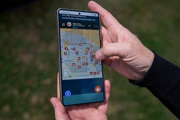 Eaton fire survivor Dr. Nicole Maccalla, a data scientist and a lead investigator, shows a website "www.efru.la" of the Eaton Contamination map she created to track lead contamination levels of tested homes in Altadena, Calif., on Friday, April 4, 2025. (AP Photo/Damian Dovarganes)