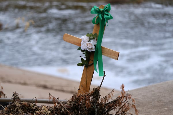 A cross stands in debris at a make-shift memorial honoring flood victims, Sunday, July 13, 2025, in Kerrville, Texas. (AP Photo/Eric Gay)