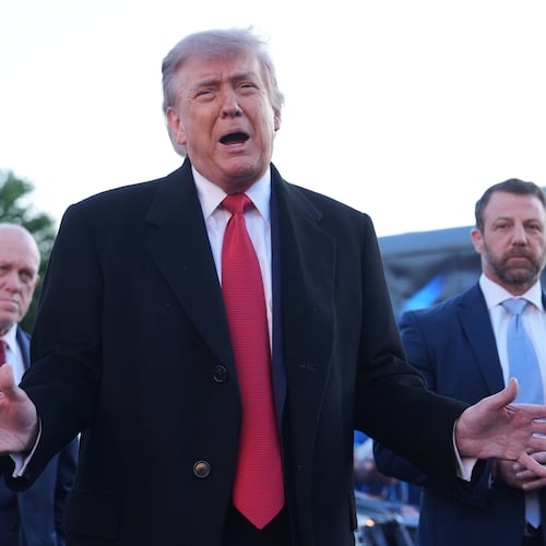 President Donald Trump speaks as he visits the Lincoln Memorial Reflecting Pool to see the new blue protective coating being applied as part of a renovation project, Thursday, May 7, 2026, in Washington, as White House boarder czar Tom Homan and Homeland Security Secretary Markwayne Mullin listen. (AP Photo/Mark Schiefelbein)