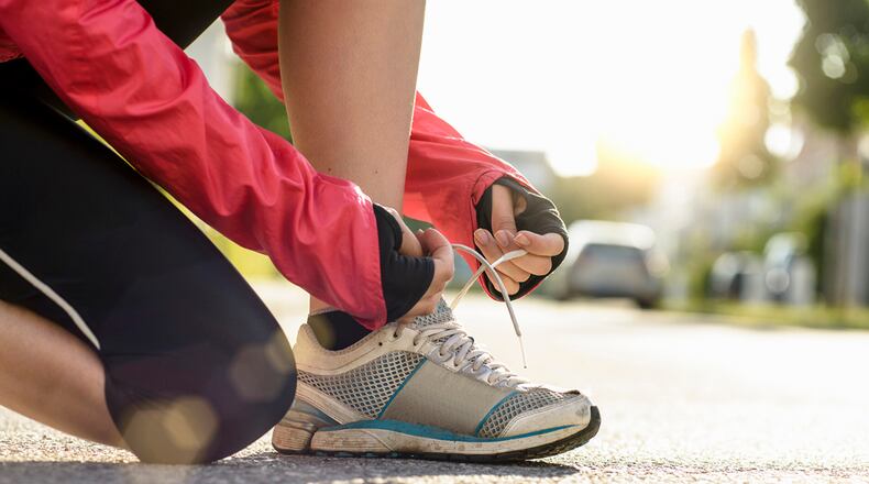 File photo of a woman tying her shoes