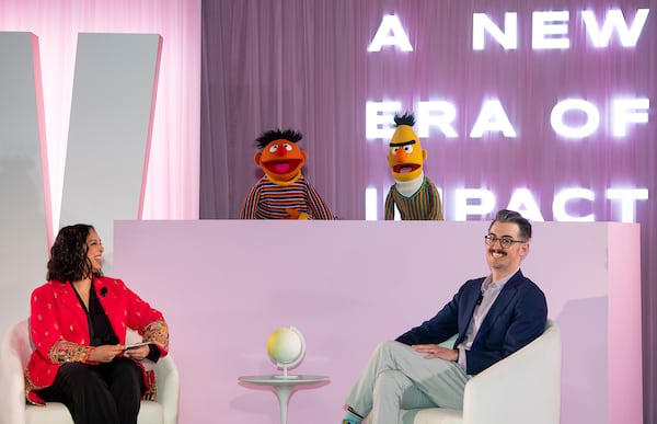 Sal Perez, executive producer and VP of Sesame Street at Sesame Workshop, right, and Versha Sharma, editor-in-chief at Teen Vogue, talk to Burt and Ernie after Sesame Workshop won the Elevate Prize Foundation's Catalyst Award, Wednesday, May 14, 2025, in Miami Beach, Fla. (AP Photo/Michael Laughlin)