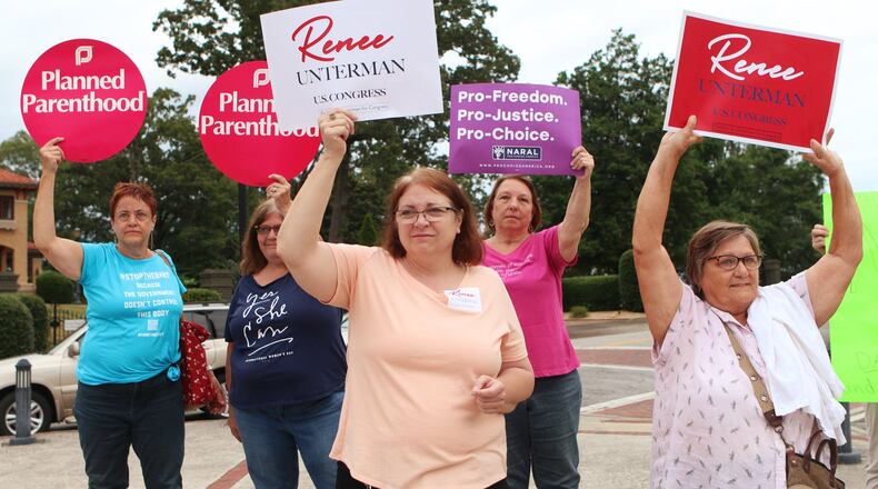 Supporters of state Sen. Renee Unterman’s bid for Congress stand in front of volunteers from Planned Parenthood who attended the state legislator’s campaign launch to protest her part in passage of Georgia’s new anti-abortion “heartbeat” law. (Christina Matacotta/christina.matacotta@ajc.com)