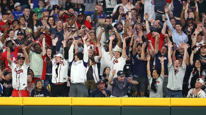 Braves fans celebrate during a 5-1 victory over the Cubs on April 28 at Truist Park. The Braves, with attendance of 789,846 through 21 games at Truist Park, are on pace to surpass 3 million in home attendance for the regular season. (Curtis Compton / Curtis.Compton@ajc.com)