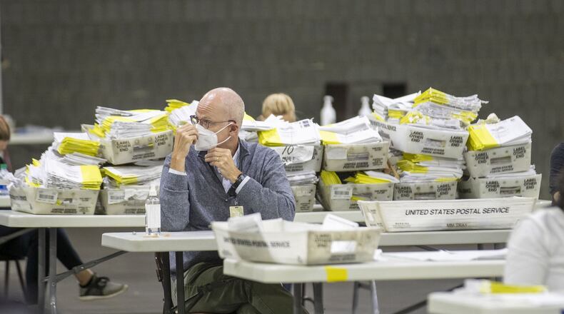 Mail-in paper ballots wait to be scanned by Fulton County employees at the Georgia World Congress Center during the Georgia primary on June 9. (ALYSSA POINTER / ALYSSA.POINTER@AJC.COM)
