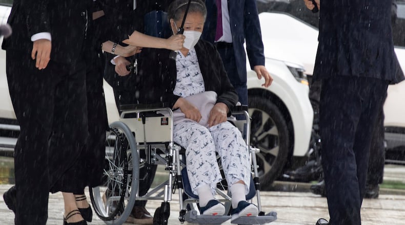Unification Church leader Hak Ja Han, on the wheelchair, arrives for the sentencing hearing on allegations of bribery and political funding, at the Seoul Central District Court in Seoul, South Korea, Monday, Aug. 31, 2026. (Jeon Heon-kyun/Pool Photo via AP)