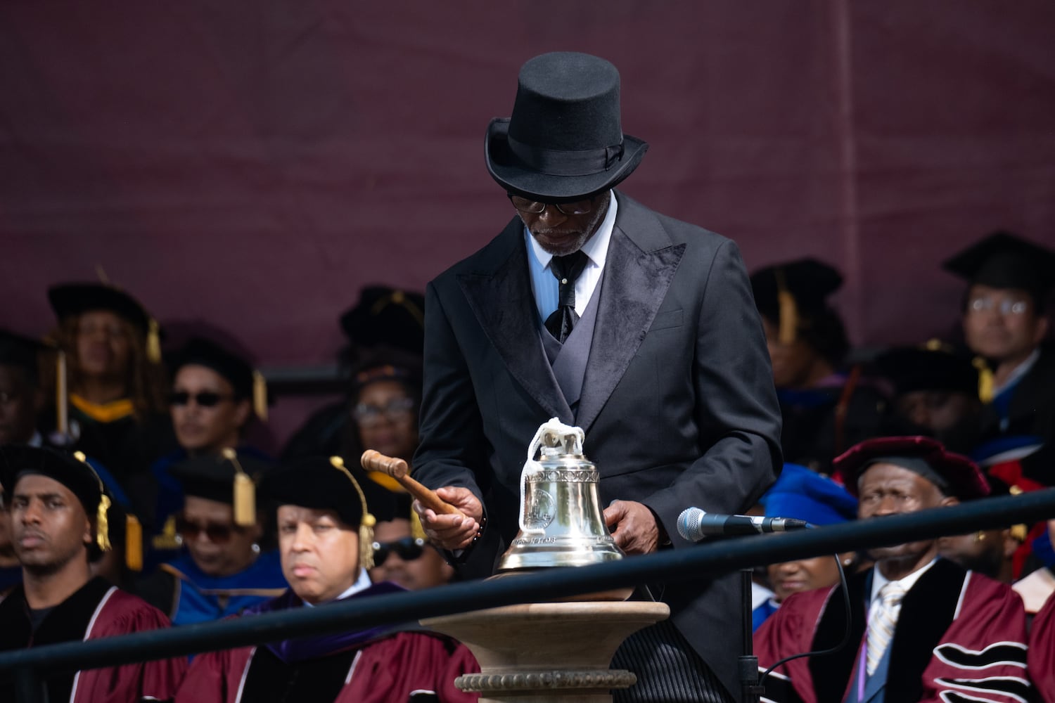 The Rev. Hardy Spurgeon Bennings III rings the bell at the beginning of the Morehouse College graduation ceremony Sunday, May 17, 2026. (Ben Gray for the AJC)